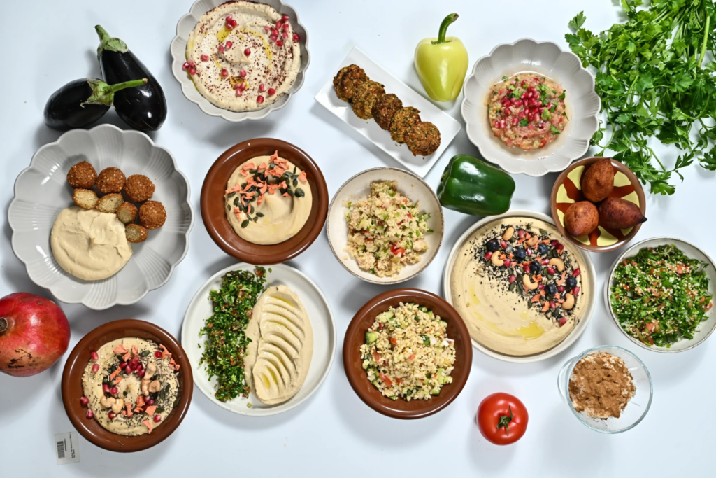 Lebanese mezze spread at Al Alamy Bali in Seminyak, with hummus, tabbouleh, dips and fresh herbs
